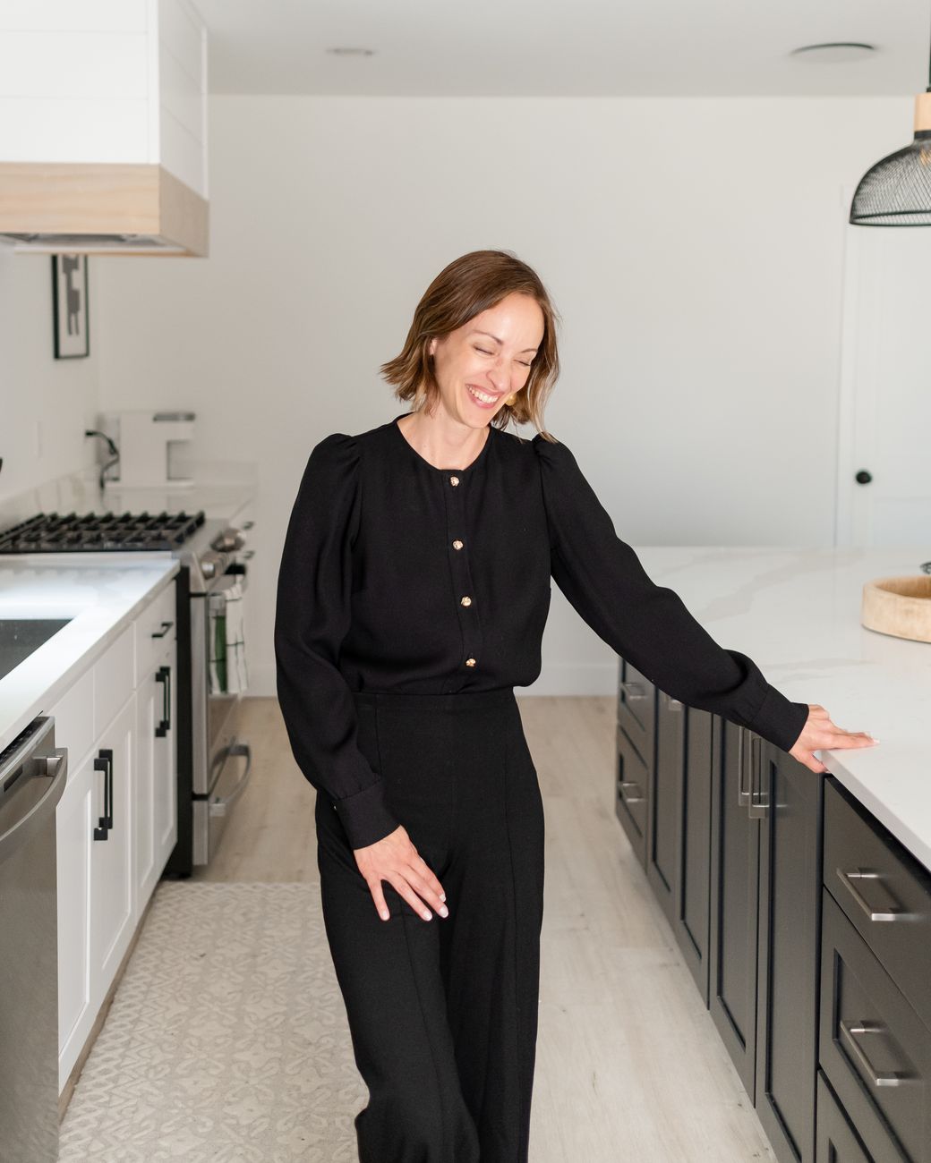 Amy Hyden laughing in a bright white kitchen