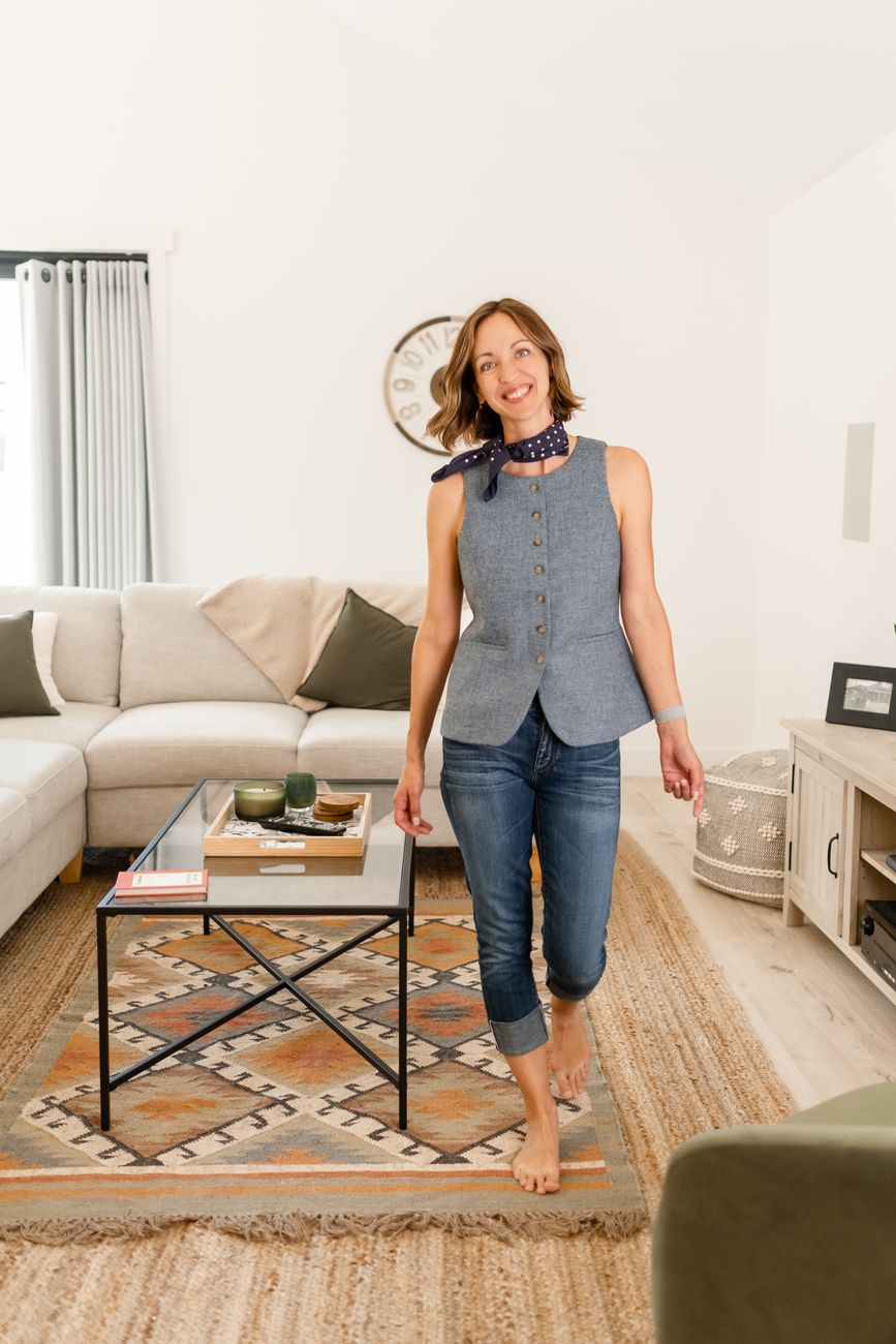Amy Hyden walking through a sunny living room