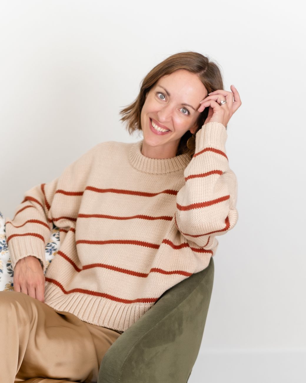 Amy smiling in a striped sweater