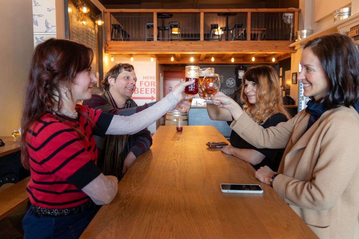 Friends raising glasses at a Ballard brewery