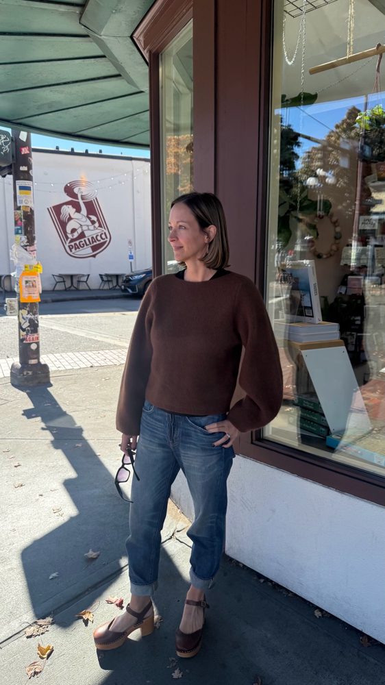 Amy standing by a shop window on Columbia City's main street