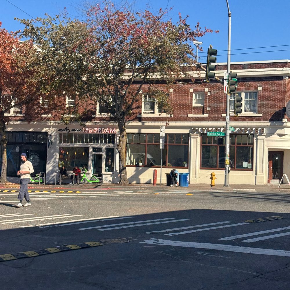 A historic brick commercial building at a Columbia City intersection