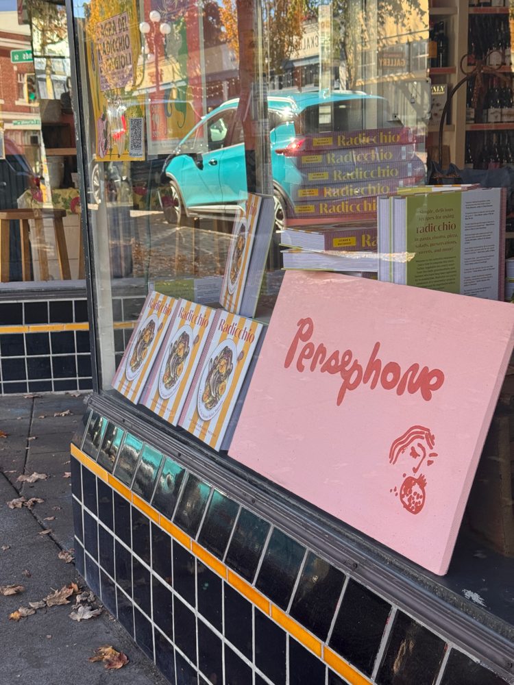 Persephone's pink sign in a Columbia City shop window