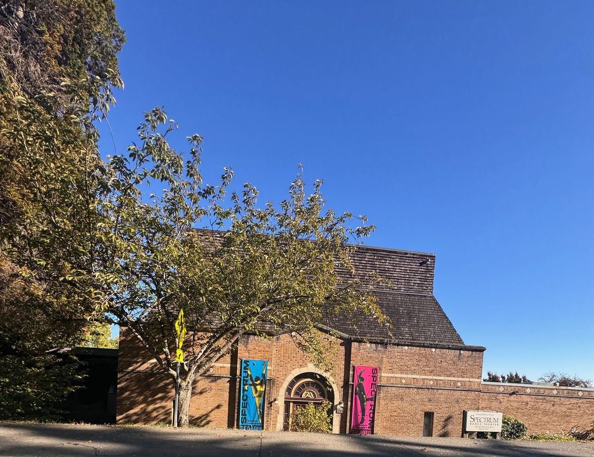 The brick Spectrum Dance Theater building with colorful banners
