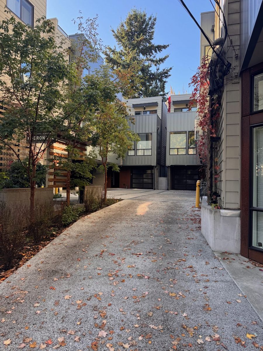 Modern townhomes set back along a leafy lane off 34th Ave