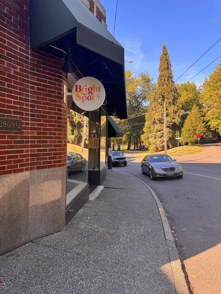 Bright Spot café's sign on a brick corner building in Mount Baker