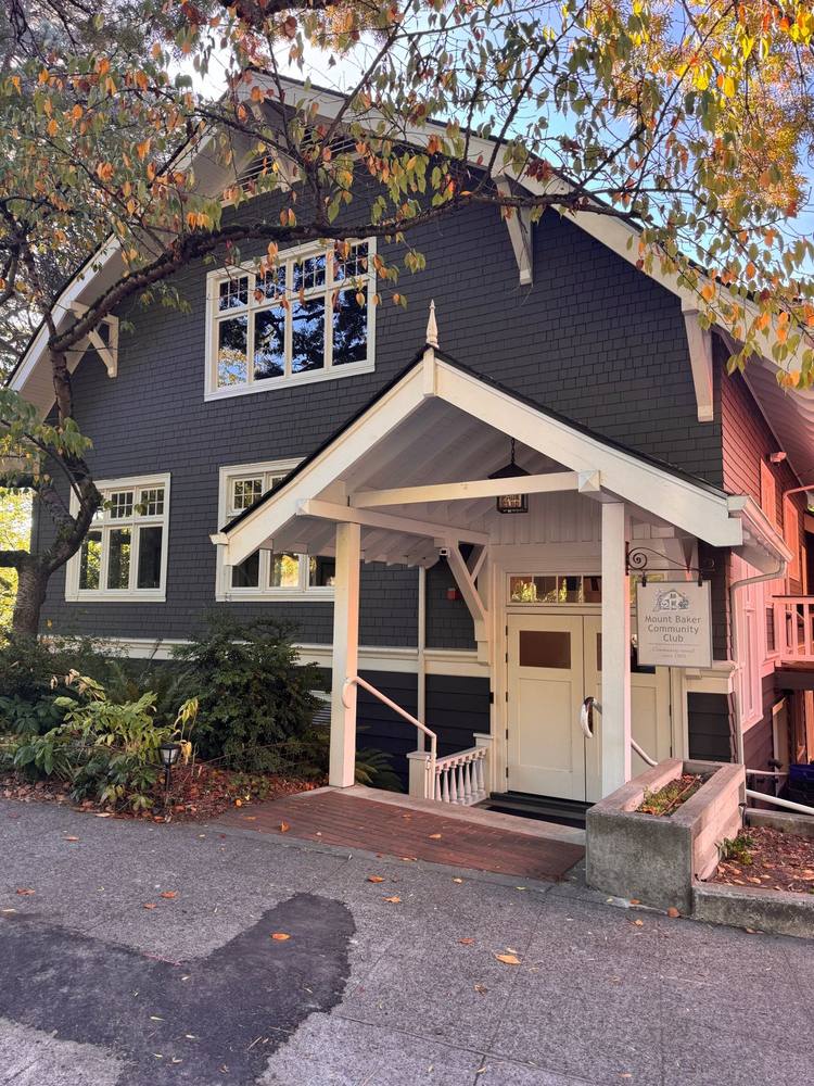 The Mount Baker Community Club clubhouse, a shingled building with a white porch and a sign reading Community owned since 1909