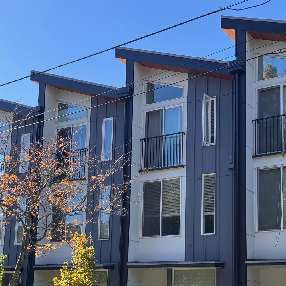 Modern three-story townhomes with small balconies in Mount Baker