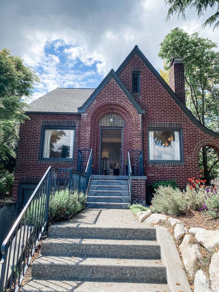 A brick Tudor home with an arched entry and steep gables in Mount Baker