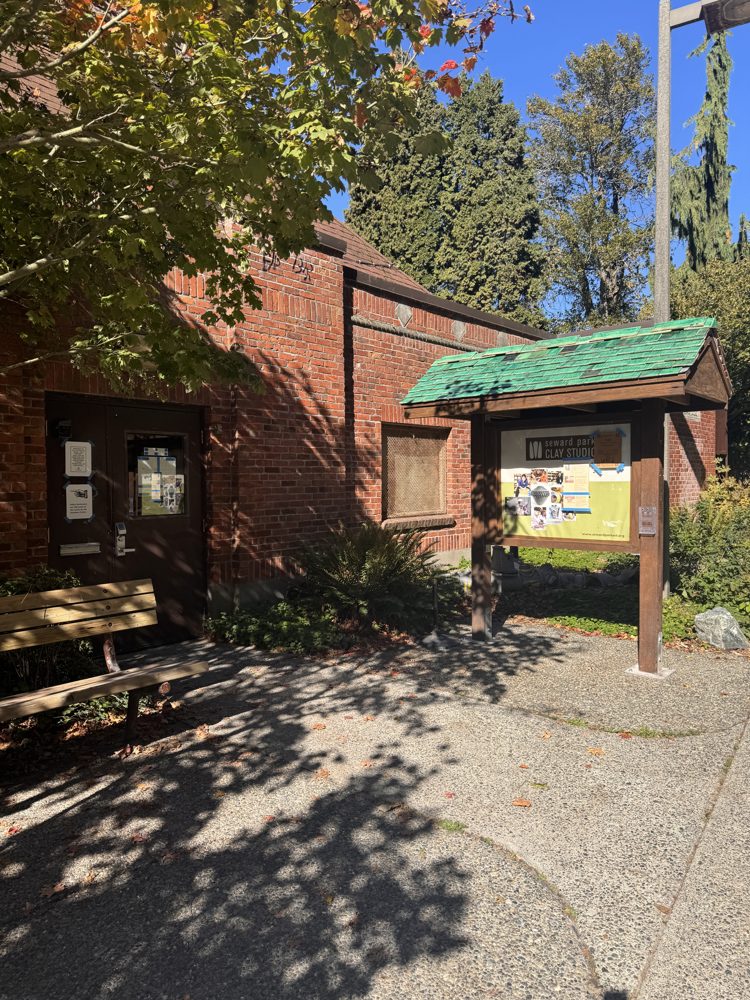 The brick Seward Park Clay Studio building with a green-roofed sign board
