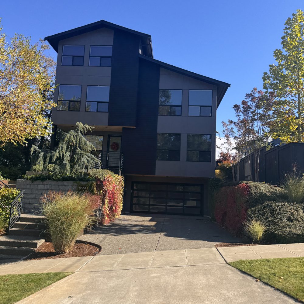 A new three-story modern home with dark siding