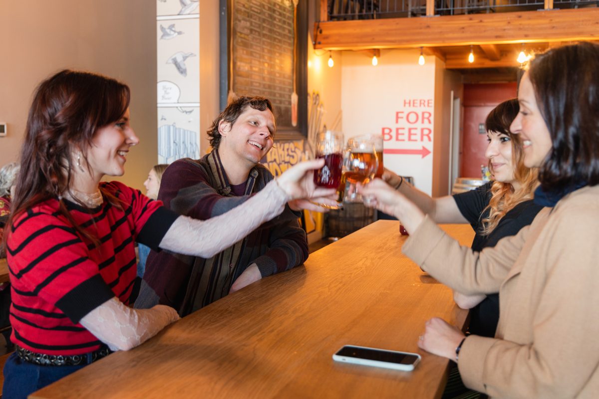 Friends raising glasses at a Ballard brewery